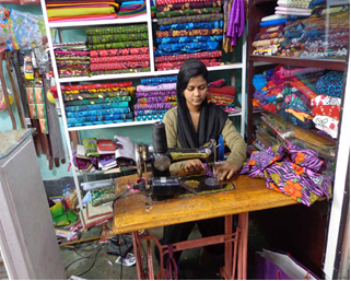 Indian Woman Tailoring in Cloth Boutique